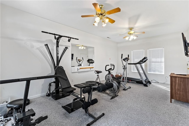 workout room with ceiling fan, baseboards, and carpet