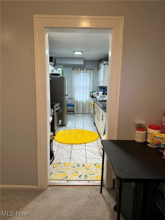 174 Colony Cres, Akron, OH 44305 - kitchen featuring appliances with stainless steel finishes, white cabinetry, and light colored carpet