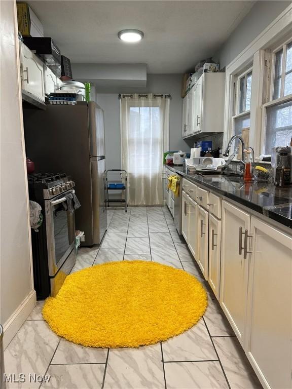 174 Colony Cres, Akron, OH 44305 - kitchen featuring gas stove, light marble finish floors, and a sink