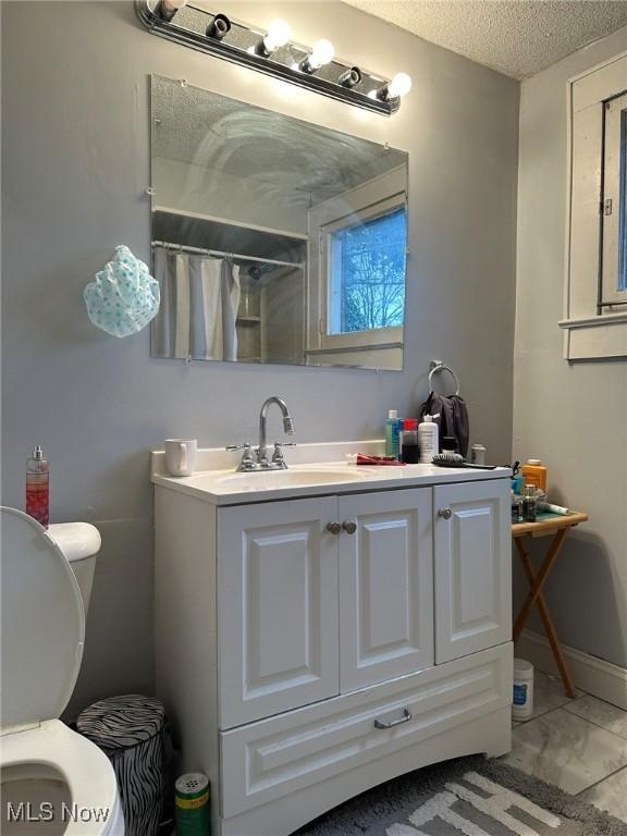 174 Colony Cres, Akron, OH 44305 - bathroom with vanity, toilet, a textured ceiling, curtained shower, and marble finish floors