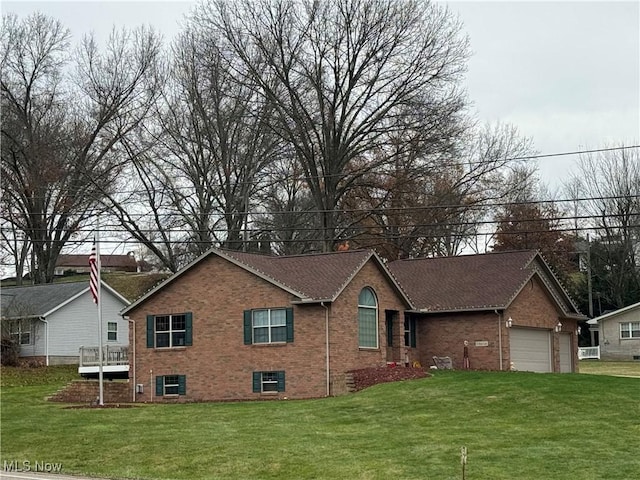 31 Briar Ln, Millersburg, OH 44654 - view of front of house with an attached garage, brick siding, and a front yard