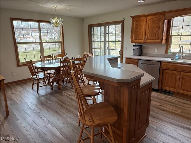 31 Briar Ln, Millersburg, OH 44654 - kitchen featuring stainless steel dishwasher, a sink, light wood-type flooring, and light countertops