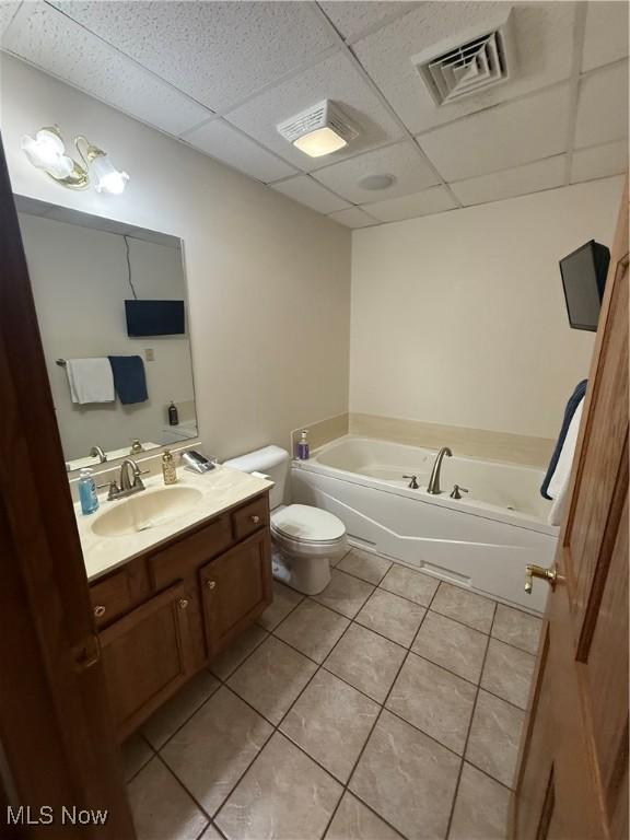 31 Briar Ln, Millersburg, OH 44654 - bathroom featuring a bath, a paneled ceiling, toilet, visible vents, and tile patterned flooring
