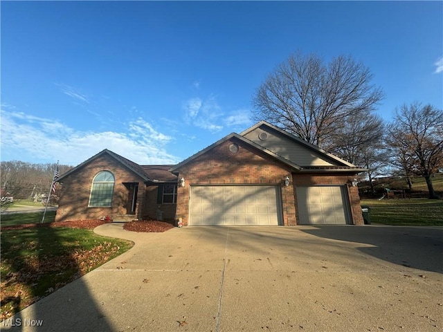 ranch-style house with an attached garage, brick siding, and driveway
