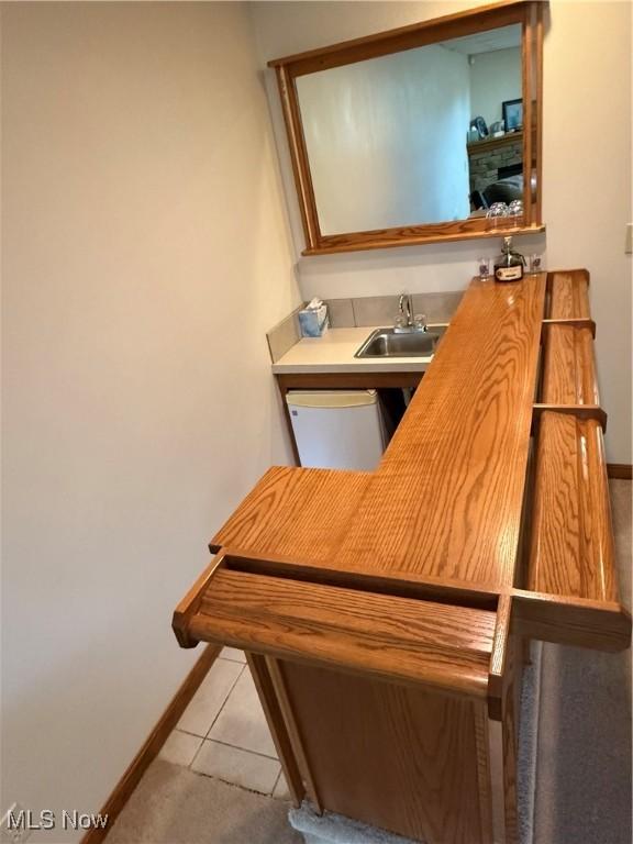 31 Briar Ln, Millersburg, OH 44654 - interior space featuring white dishwasher, baseboards, indoor wet bar, and a sink