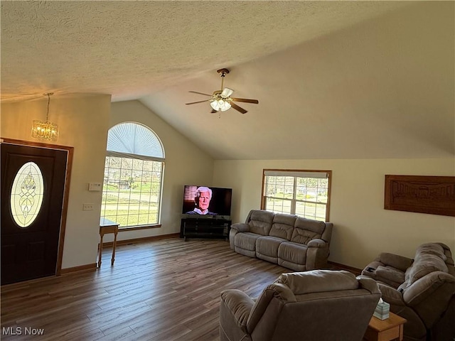 31 Briar Ln, Millersburg, OH 44654 - living room with baseboards, vaulted ceiling, dark wood-style floors, and ceiling fan with notable chandelier