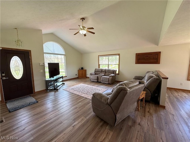 31 Briar Ln, Millersburg, OH 44654 - living area with high vaulted ceiling, a ceiling fan, wood finished floors, baseboards, and visible vents
