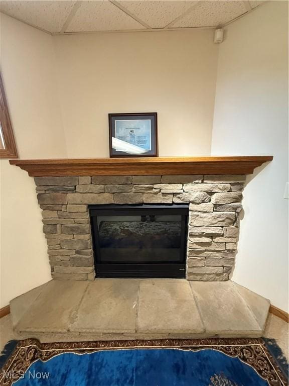 31 Briar Ln, Millersburg, OH 44654 - interior details featuring a paneled ceiling, baseboards, and a stone fireplace