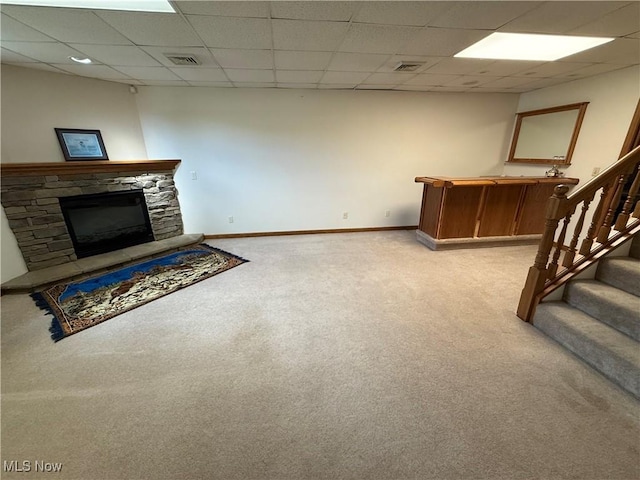 31 Briar Ln, Millersburg, OH 44654 - unfurnished living room with a paneled ceiling, visible vents, light colored carpet, and stairs