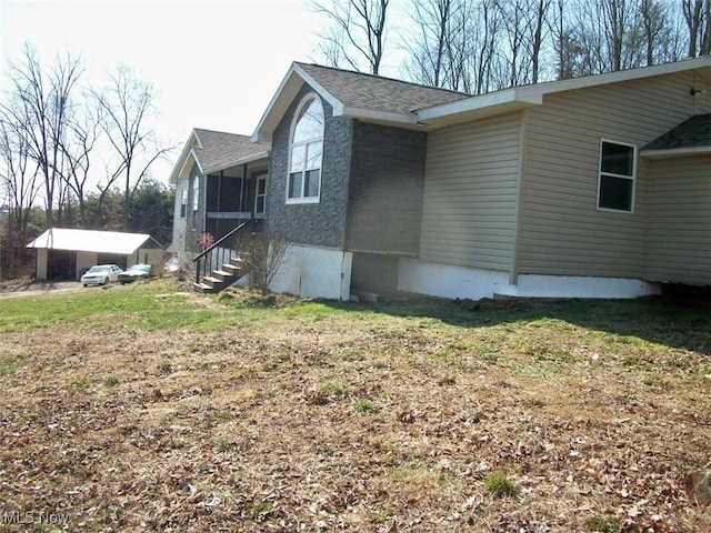 8045 State Route 555, Cutler, OH 45724 - view of home's exterior with a sunroom and roof with shingles