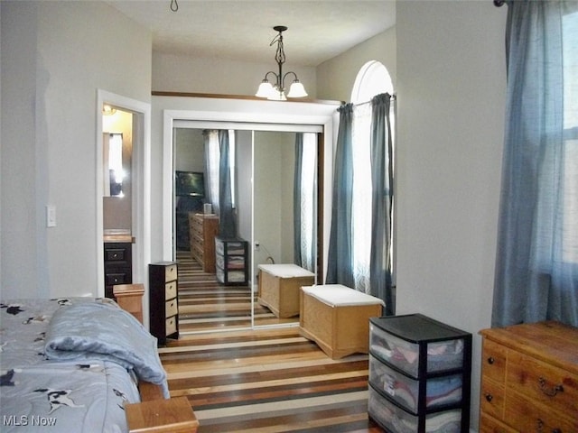 8045 State Route 555, Cutler, OH 45724 - bedroom featuring a closet, a notable chandelier, and light wood-style flooring