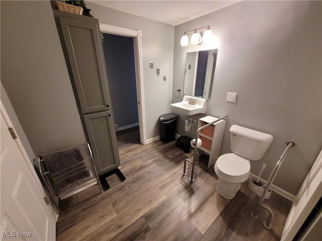 145 Maplewood Ave, Rittman, OH 44270 - bathroom with a sink, toilet, baseboards, and wood finished floors