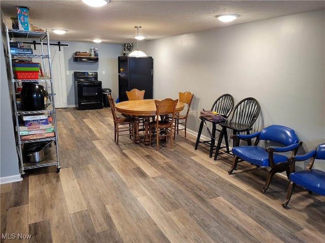 145 Maplewood Ave, Rittman, OH 44270 - dining space featuring a textured ceiling, baseboards, and wood finished floors