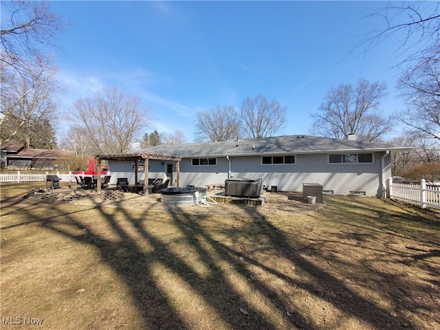 145 Maplewood Ave, Rittman, OH 44270 - rear view of property featuring fence, a lawn, cooling unit, a chimney, and a jacuzzi