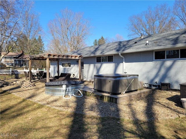 145 Maplewood Ave, Rittman, OH 44270 - back of property featuring brick siding, a hot tub, fence, a patio area, and a pergola