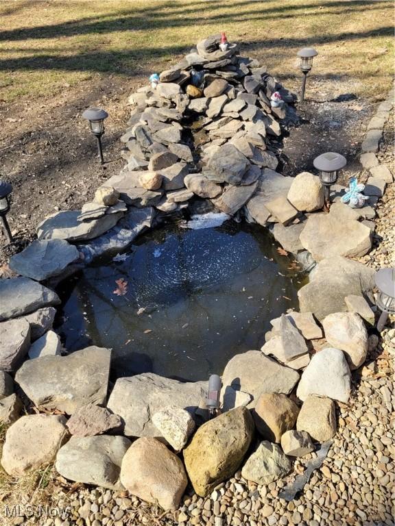 145 Maplewood Ave, Rittman, OH 44270 - exterior details with a garden pond