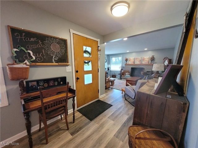 145 Maplewood Ave, Rittman, OH 44270 - entryway featuring a fireplace, baseboards, and wood finished floors