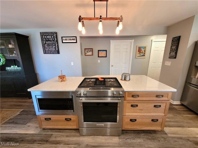 145 Maplewood Ave, Rittman, OH 44270 - kitchen featuring decorative light fixtures, stainless steel appliances, dark wood finished floors, and light countertops