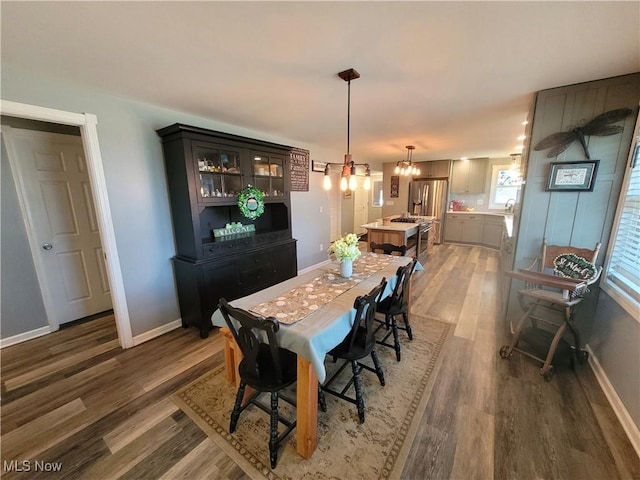 145 Maplewood Ave, Rittman, OH 44270 - dining room with an inviting chandelier, wood finished floors, and baseboards