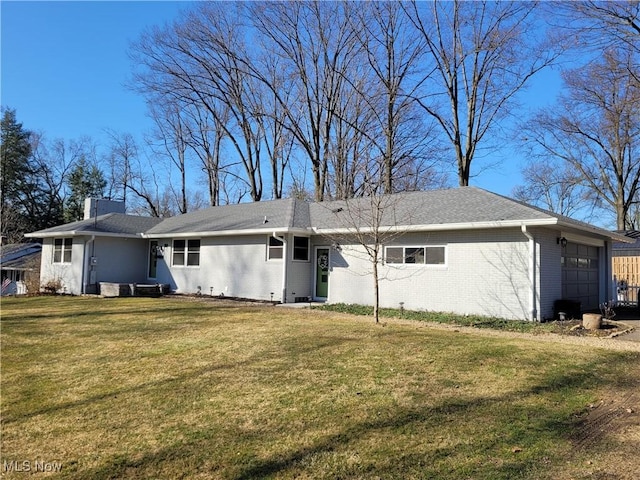 145 Maplewood Ave, Rittman, OH 44270 - back of house with a yard, brick siding, and an attached garage