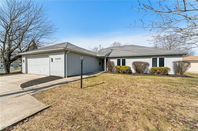 view of front of home featuring concrete driveway, a garage, and a front lawn