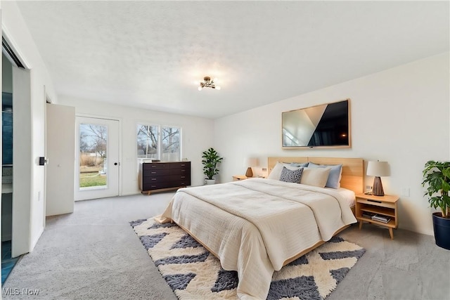 carpeted bedroom featuring access to outside