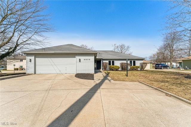 single story home with concrete driveway and a garage