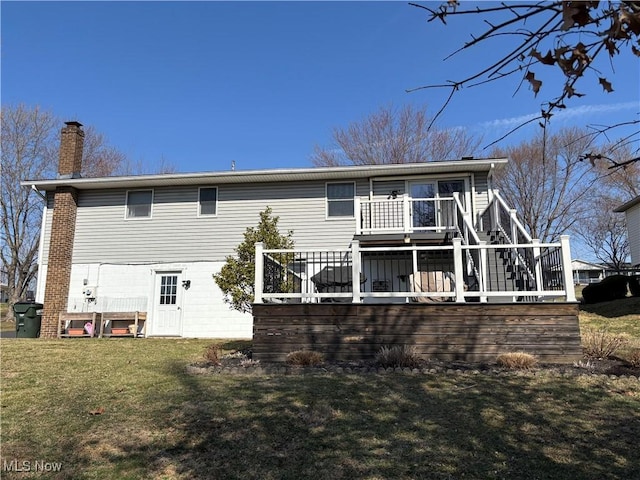 back of house with a wooden deck, stairway, a lawn, and a chimney