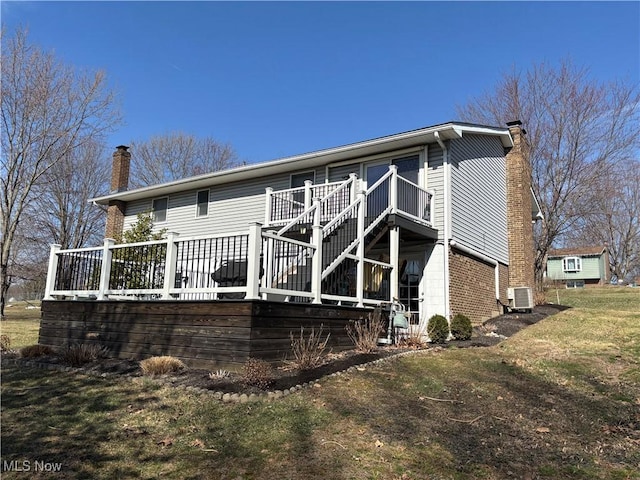 back of house featuring a deck, a chimney, stairs, and central AC