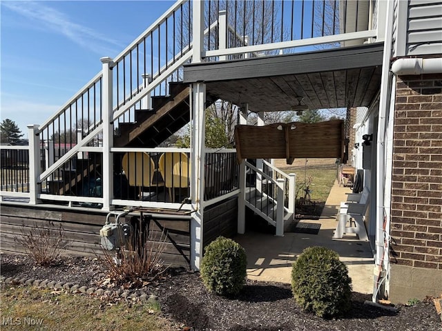 exterior space with brick siding and stairs