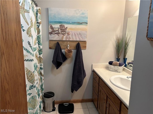bathroom featuring baseboards, a shower with curtain, vanity, and tile patterned flooring