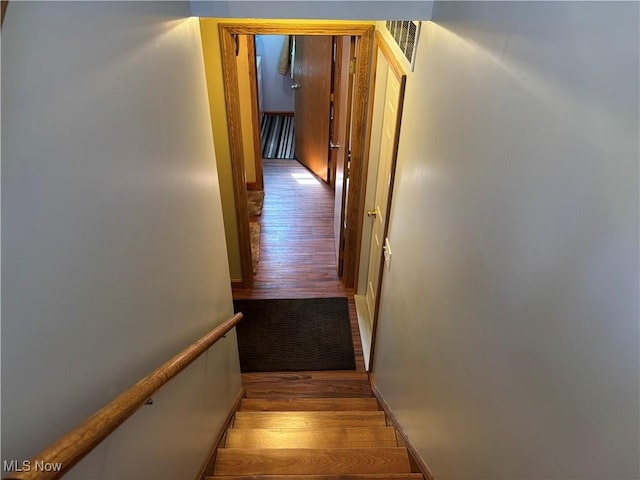 hallway featuring visible vents and wood finished floors