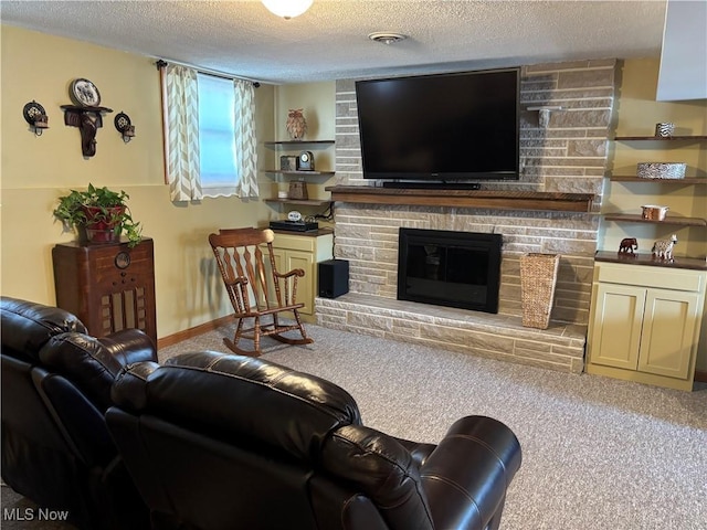 living area featuring carpet, visible vents, baseboards, a stone fireplace, and a textured ceiling