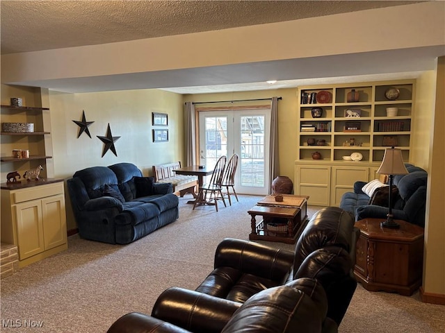 carpeted living area with a textured ceiling