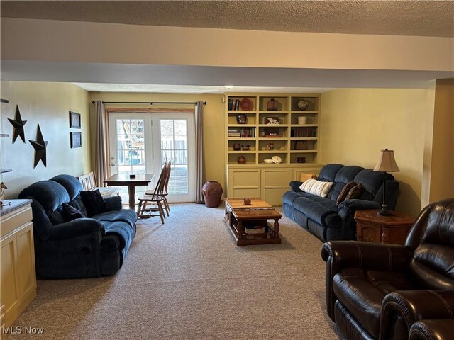 carpeted living area with a textured ceiling