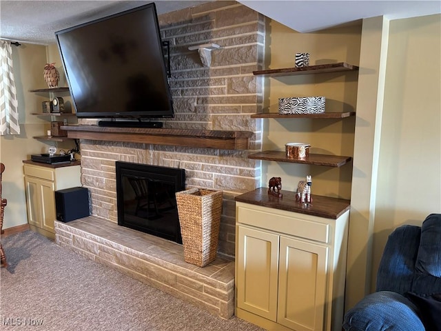 living room featuring a fireplace and carpet