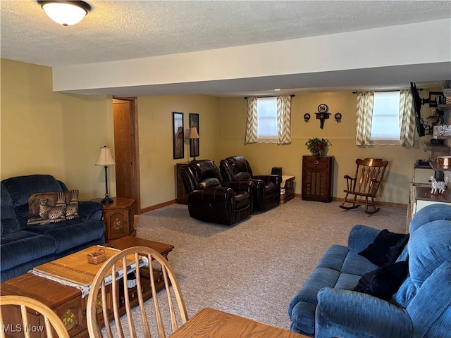 living room with carpet flooring, a textured ceiling, and baseboards