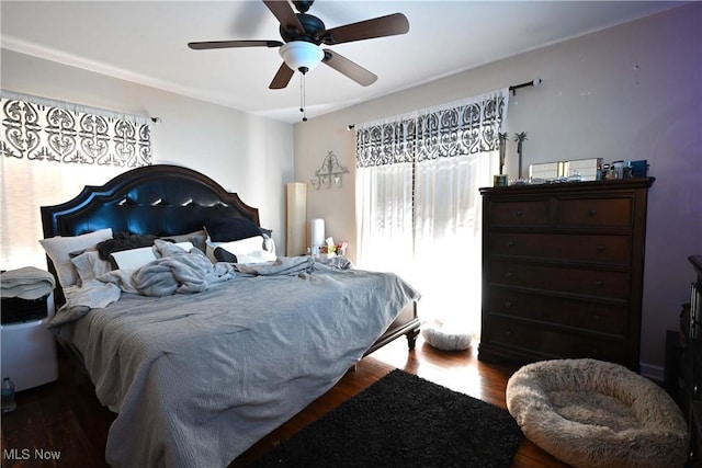 bedroom with a ceiling fan and wood finished floors