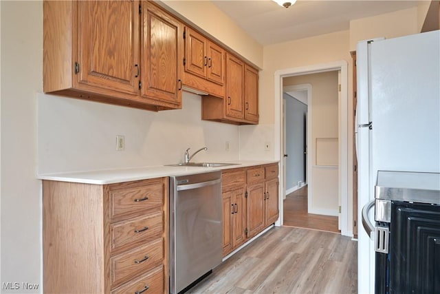 kitchen with dishwasher, light countertops, light wood-type flooring, brown cabinetry, and a sink