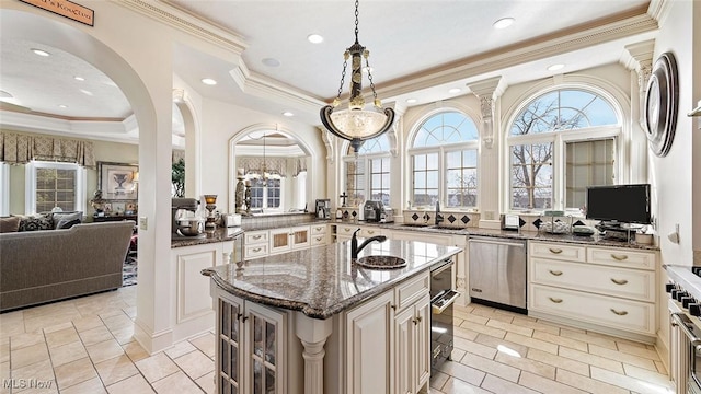 1524 Eagle Watch St NE, Canton, OH 44721 - kitchen featuring dark stone countertops, a tray ceiling, arched walkways, a sink, and stainless steel dishwasher