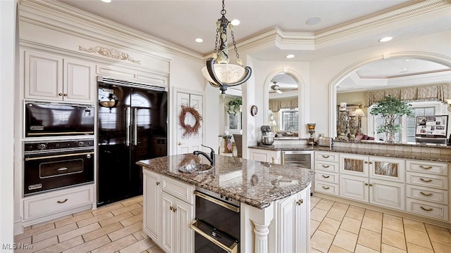 1524 Eagle Watch St NE, Canton, OH 44721 - kitchen with a center island, crown molding, dark stone counters, freestanding refrigerator, and a raised ceiling