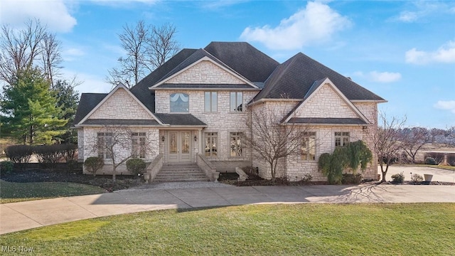 1524 Eagle Watch St NE, Canton, OH 44721 - view of front of property with a front yard, concrete driveway, french doors, and stone siding
