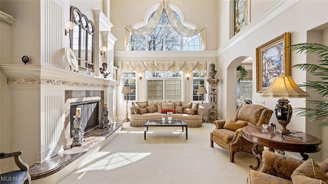 1524 Eagle Watch St NE, Canton, OH 44721 - living room featuring a fireplace, carpet, arched walkways, and a towering ceiling