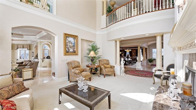 1524 Eagle Watch St NE, Canton, OH 44721 - carpeted living area with arched walkways, a high ceiling, crown molding, and ornate columns