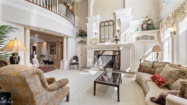 1524 Eagle Watch St NE, Canton, OH 44721 - carpeted living area with a premium fireplace, a towering ceiling, ornamental molding, and ornate columns