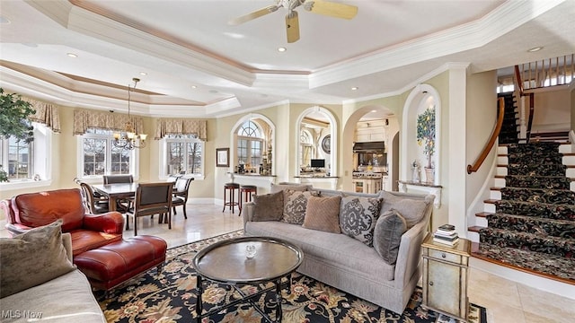 1524 Eagle Watch St NE, Canton, OH 44721 - tiled living area with stairs, a tray ceiling, ornamental molding, ceiling fan with notable chandelier, and arched walkways