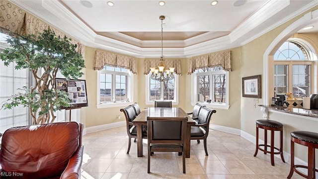 1524 Eagle Watch St NE, Canton, OH 44721 - dining area with a notable chandelier, a raised ceiling, arched walkways, crown molding, and baseboards