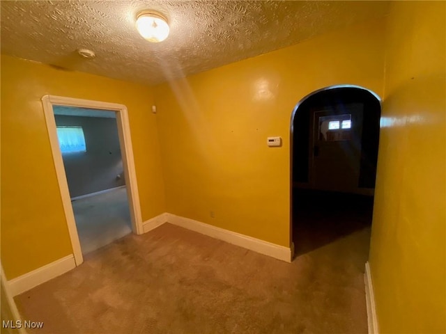 5208 Orchard Park Dr, Parma, OH 44134 - corridor featuring baseboards, arched walkways, a textured ceiling, and carpet flooring