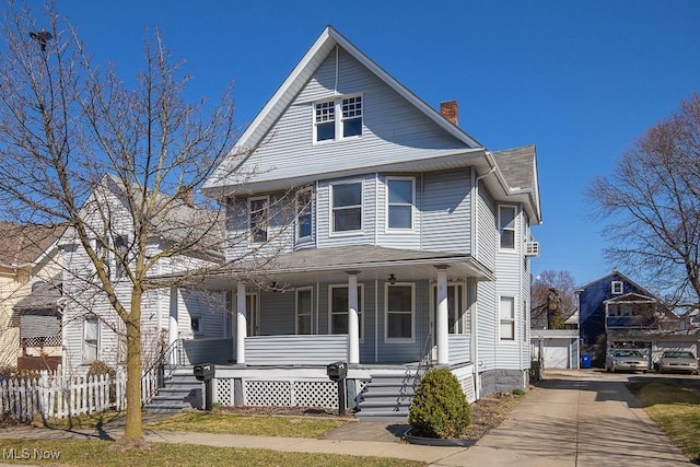 2047 W 93rd St, Cleveland, OH 44102 - view of front facade with a detached garage, fence, a porch, a chimney, and an outdoor structure