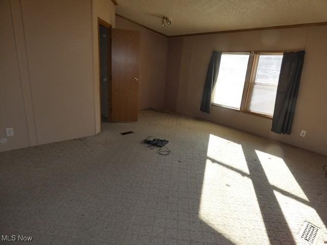 11380 Valley Dr, The Plains, OH 45780 - unfurnished room featuring visible vents, a textured ceiling, and lofted ceiling
